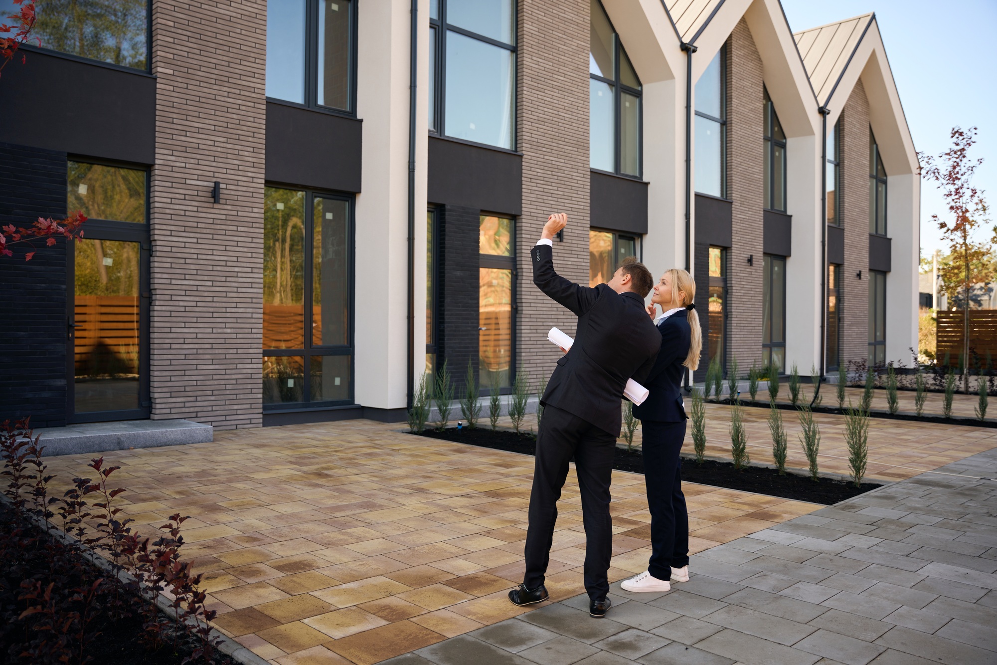 Male architect and female client having real estate inspection