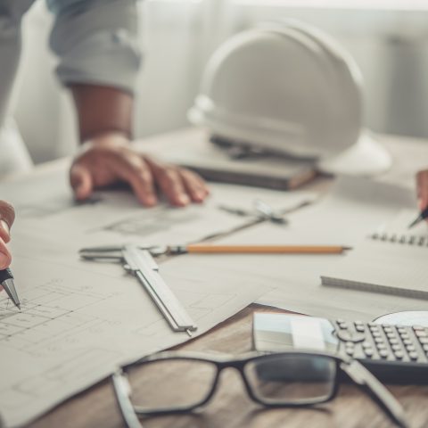 engineer working in office with blueprints, inspection in workplace for architectural plan